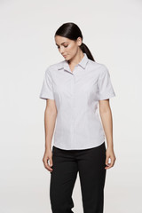 A short sleeve button-up shirt in white, featuring a fitted design and a collar, with a logo present.