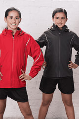 A red and a dark grey jacket are worn by two children, both wearing shorts, in a bright setting.