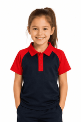 A girl smiles while wearing a navy blue and red polo shirt. The shirt features a logo on the front.