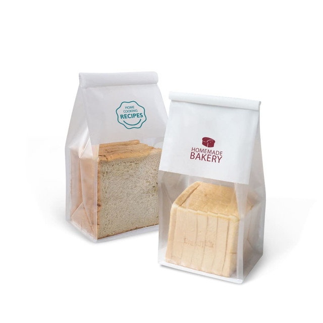 Clear sealing storage bags containing loaves of bread. One bag has a logo and the other features a recipe insignia.