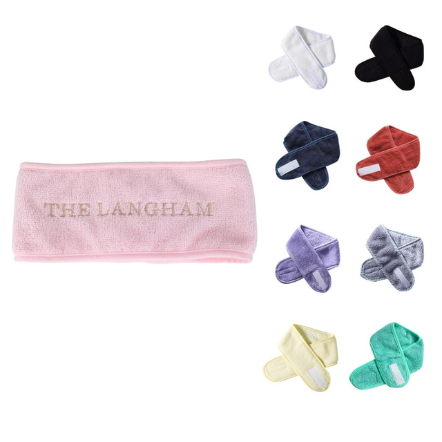 A selection of headbands in various colours including pink, white, black, navy, purple, grey, yellow, and green, with one featuring a logo.