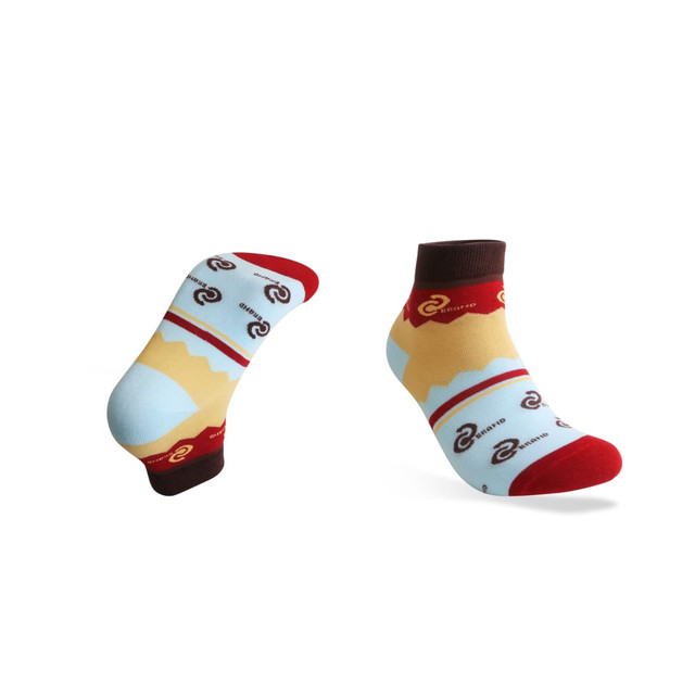 Ankle socks featuring a custom pattern in blue, yellow, and red with a logo design.