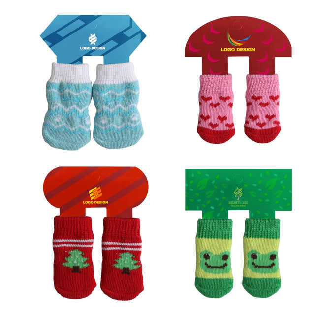 Four pairs of pet socks in various colours: blue with patterns, pink with hearts, red with Christmas trees, and green with a smiling face. Each pair is displayed on cards with logos.