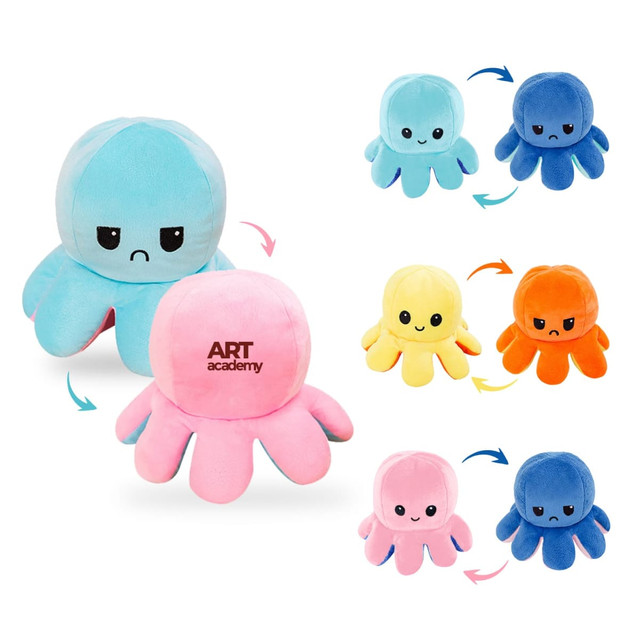 A large, reversible octopus plush toy in blue and pink, featuring happy and sad expressions. It has a logo on one side.