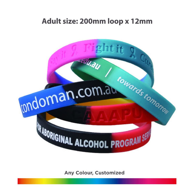 A collection of silicone wristbands in various colours, featuring different text and a logo on some bands.