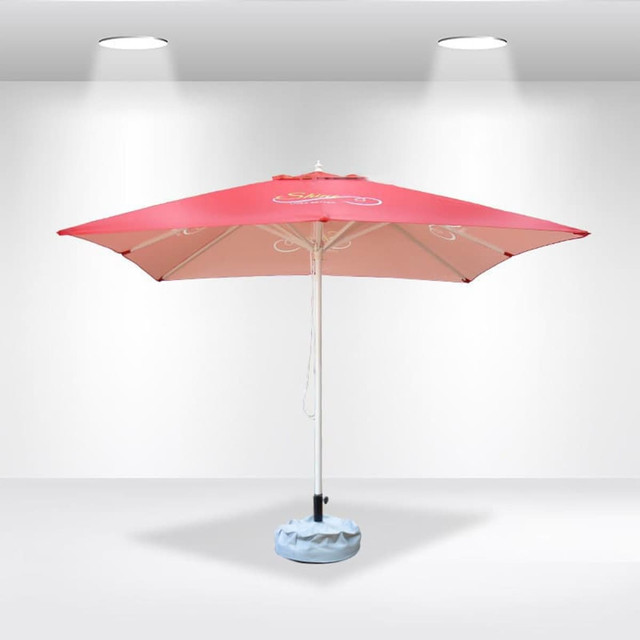 A pink 3x3m square market umbrella with a light blue base and a logo on the canopy.