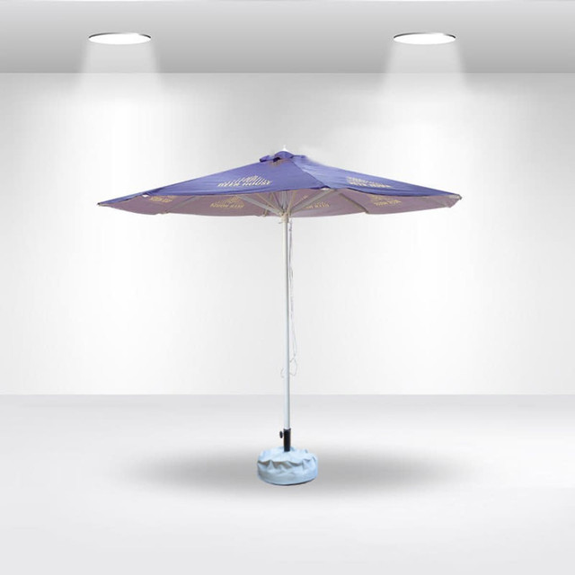 A purple round market umbrella with a light blue base, featuring a central pole and branding.