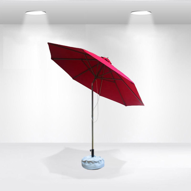 A red tilting patio umbrella with a light blue base, designed for outdoor use. It features a metal pole and canopy.