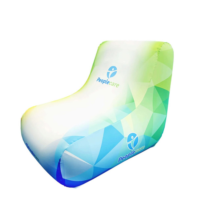 An inflatable lounge chair in green and blue with a geometric pattern and a logo.