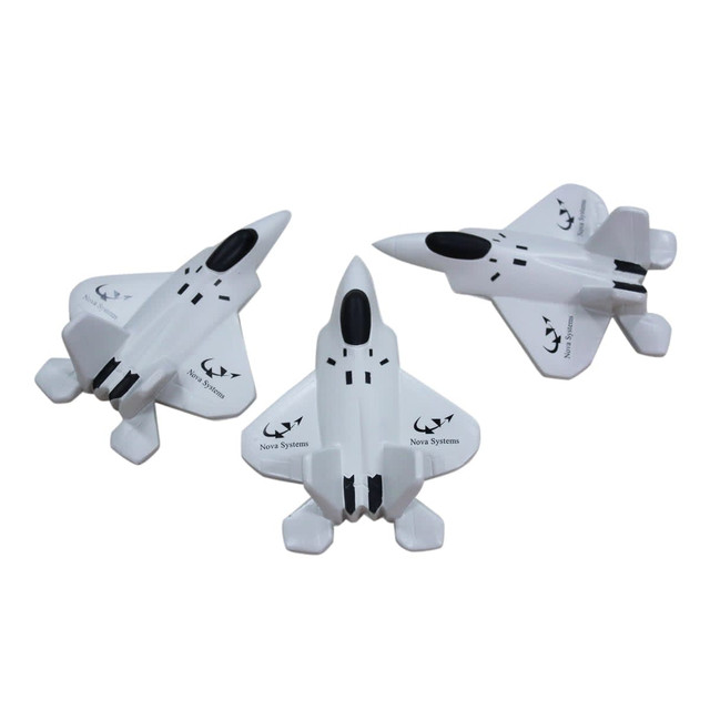 Three white stress relievers shaped like fighter jets, featuring a logo and sleek designs.