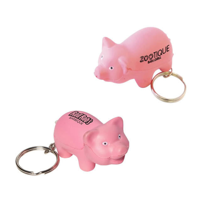 A pink keyring featuring a mini pig stress item, with a keyring attachment and a logo on its side.