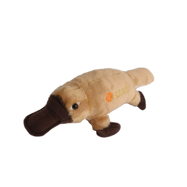 A beige and brown platypus plush toy with embroidered details and a logo. Ideal for fun and games.