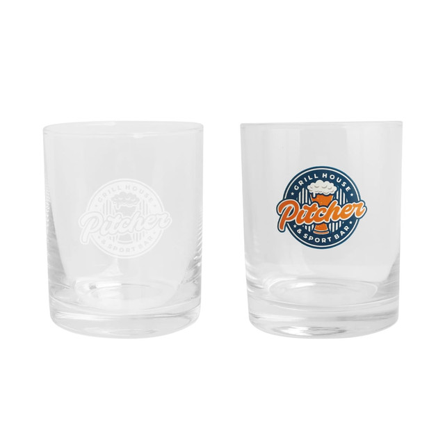A whiskey glass set featuring clear glass with a logo, one etched and one coloured in orange and blue.