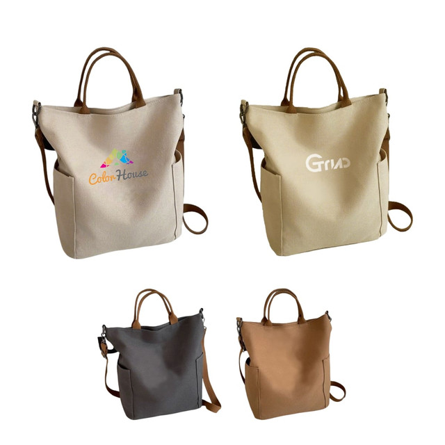 A vintage style canvas bag in beige, grey, and brown with leather handles and a logo on each.