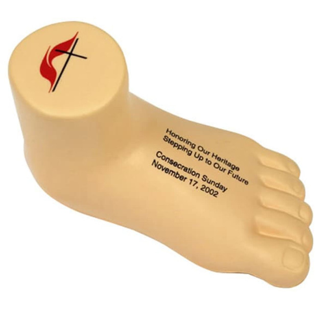 A leg-shaped stress reliever in beige with a logo on top, designed for stress relief and fun.