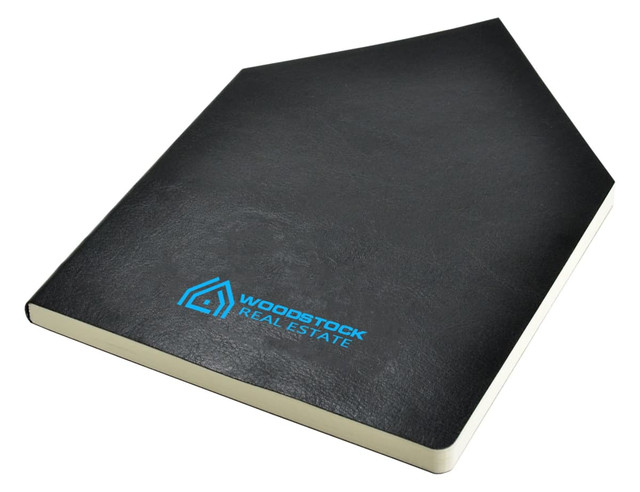 A black A5 notebook with a textured cover and a logo on the front.