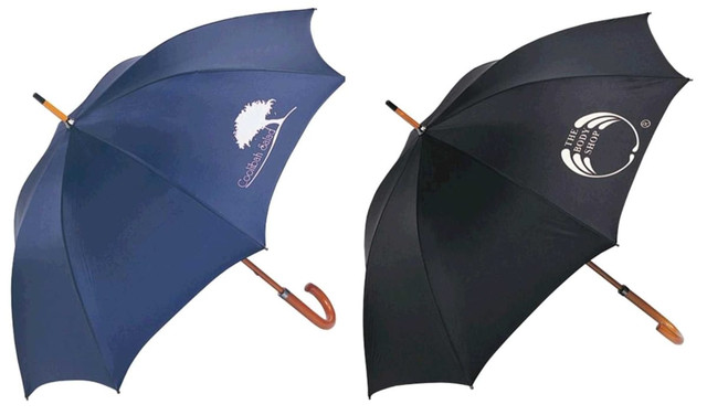 Two umbrellas are displayed, one in navy blue with a logo and the other in black with a logo, both featuring a curved handle.
