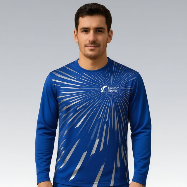 A blue long-sleeved shirt with a silver graphic design and a logo on the front.