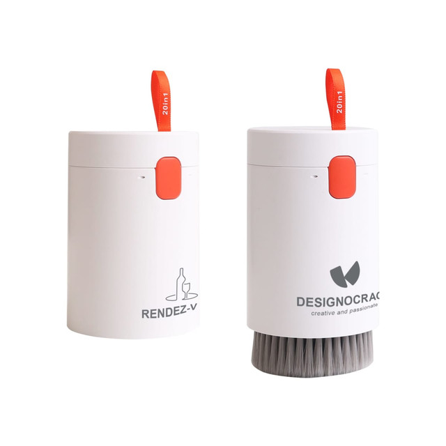 A compact white cleaning kit featuring a brush and a storage container, with an orange accent and branding on one side.