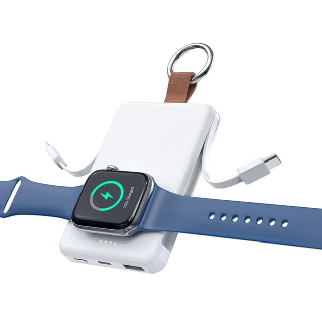 A white magnetic power bank with a brown leather strap, with a blue smartwatch attached for charging. A white magnetic power bank with a brown leather strap, with a blue smartwatch attached for charging.