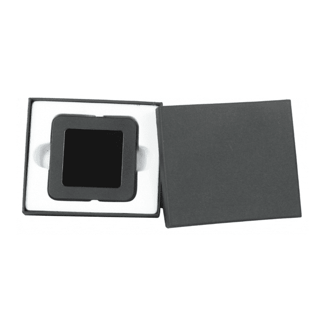 A square black item packaged in a grey box with a white lining, featuring a simple design and logo.