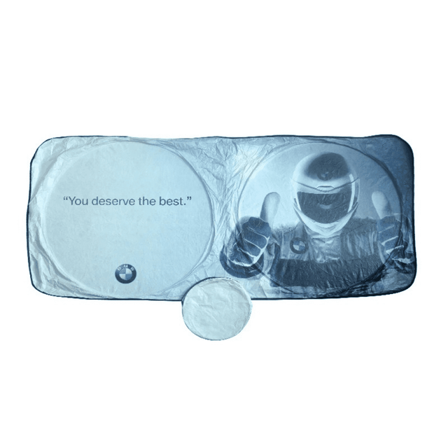 A foldable car sun visor featuring a blue and white design, with a logo and an illustration of a helmeted figure giving a thumbs up.