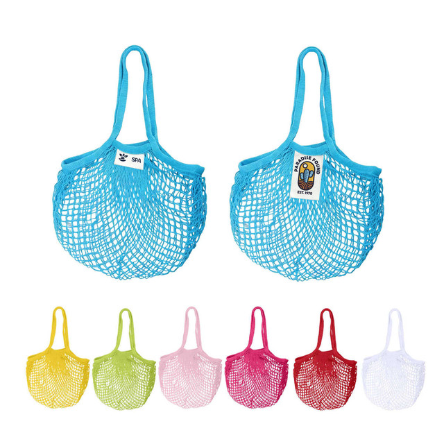 Two mesh grocery bags in blue, with a logo, alongside bags in yellow, pink, red, and white.