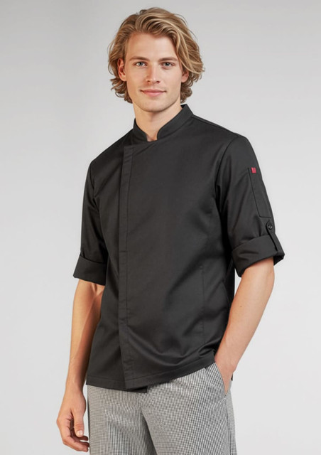 A black long sleeve chef jacket with rolled-up sleeves, modelled by a young man. It features a logo on one sleeve.