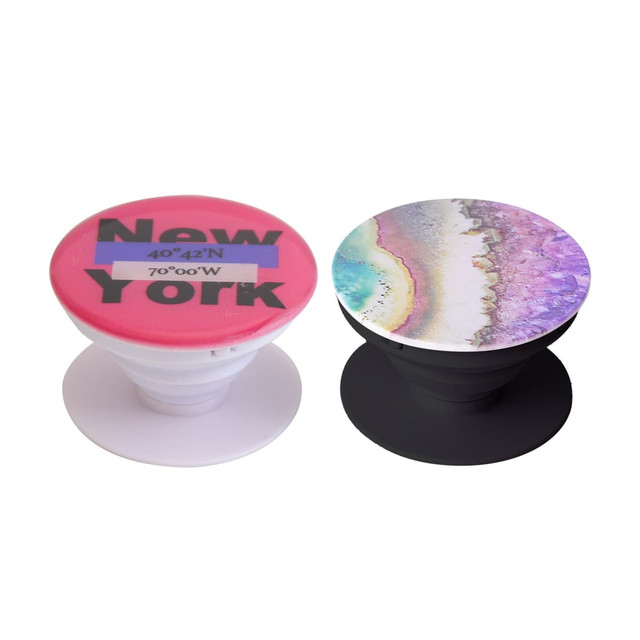 Two phone pop holders in different designs: one pink with text and one featuring a colourful abstract pattern. Both have a logo.