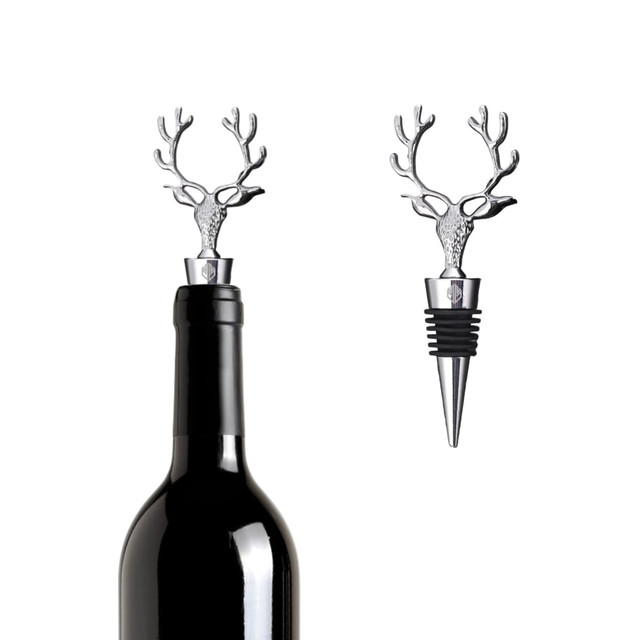 A drink bottle topped with a silver deer head wine stopper, featuring antlers and a rubber base for sealing.