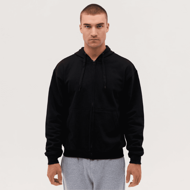 A black zip-up hooded sweatshirt on a model, featuring a front zipper and drawstring hood.