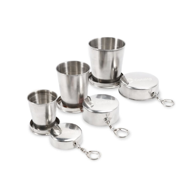 A compact set of stainless steel folding cups in silver, featuring three different sizes with keychain attachments.