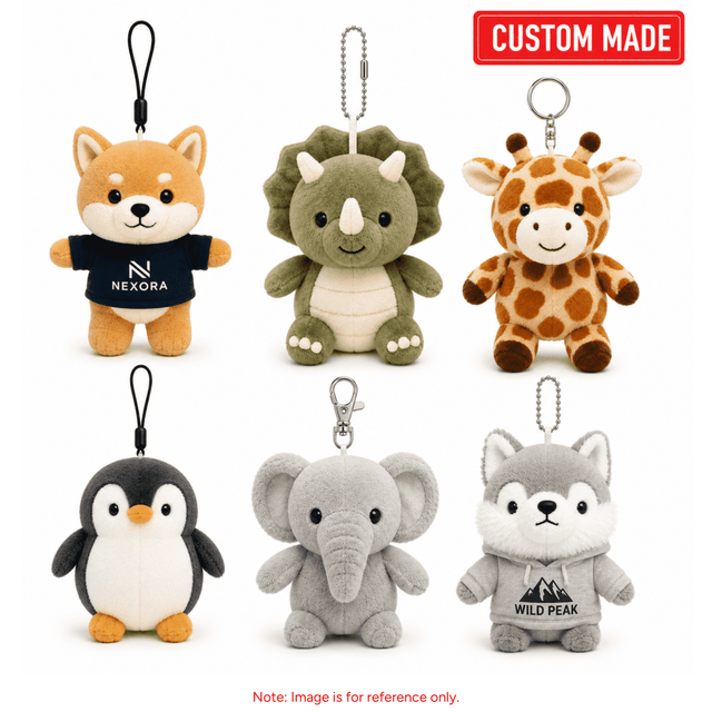 A selection of six cute plush animal keyrings, including a penguin, elephant, giraffe, and wolf, in various colours.
