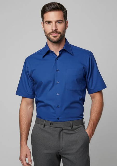 A blue short sleeve button-up shirt with a chest pocket, featured on a male model. The shirt has a logo on it.