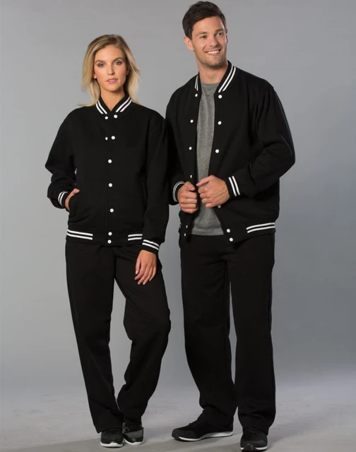 A black fleece varsity jacket with white stripes, worn by a woman and a man, both in matching black pants.