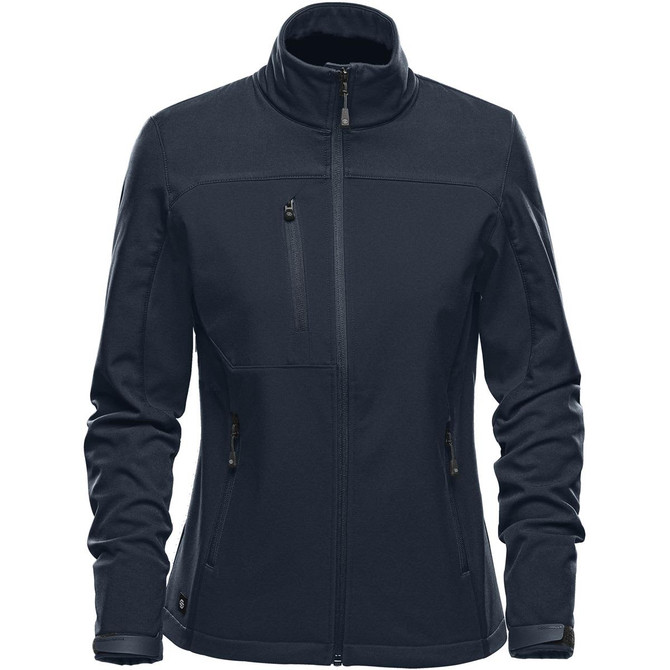 A women's softshell jacket in navy blue featuring a stand collar and multiple zippered pockets. It has a logo on it.