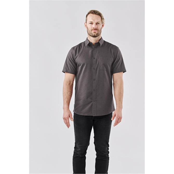 A short-sleeved men's button-up shirt in dark grey with a subtle pattern, featuring a logo on the chest.