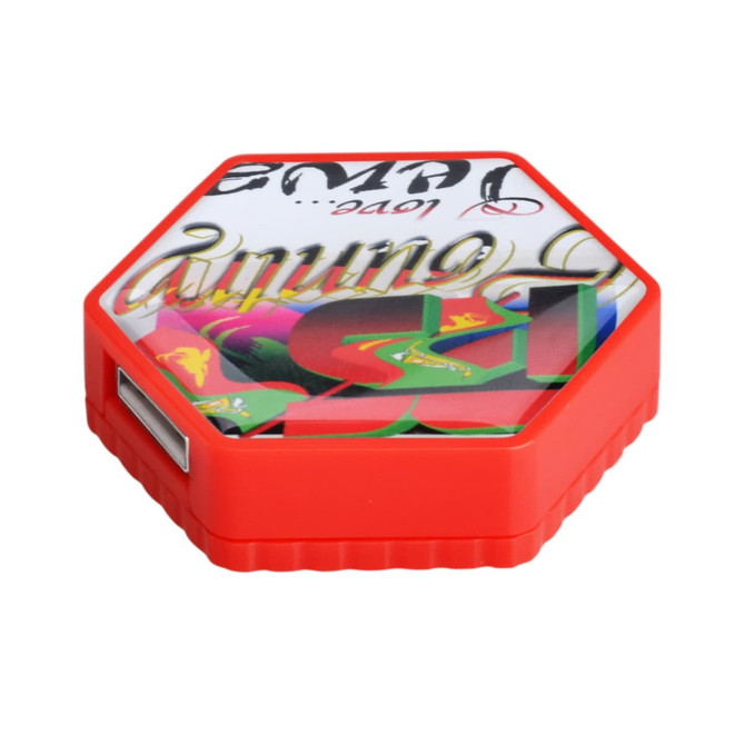 A hexagon-shaped flash drive in bright red, featuring a decorative design on the top and a USB port on the side.