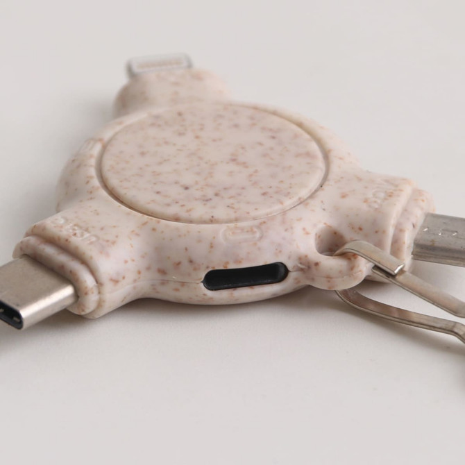 A 3-in-1 wheat straw data blocker with keyring in a speckled beige colour featuring USB connectors.