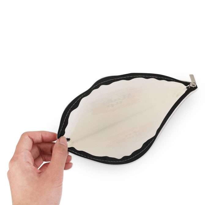 A hand holding a rectangle canvas cosmetic bag in black, featuring a clear interior and a zip closure.
