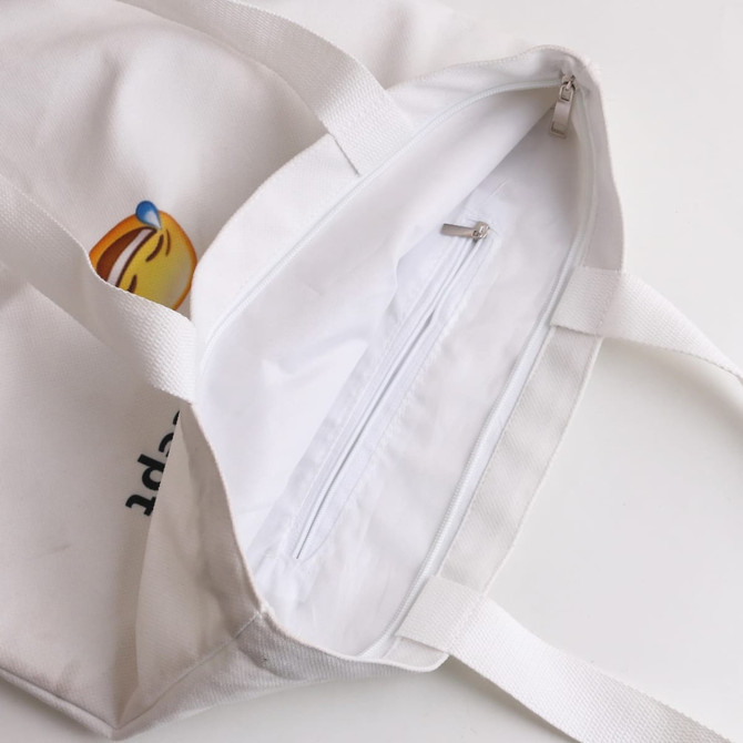 A white velvet tote bag with a zip pocket inside and dual handles. It features a logo design.