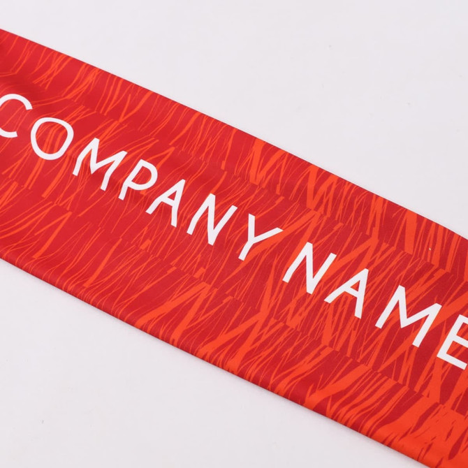 A red sublimated fabric with a textured pattern, featuring a logo or branding prominently displayed.