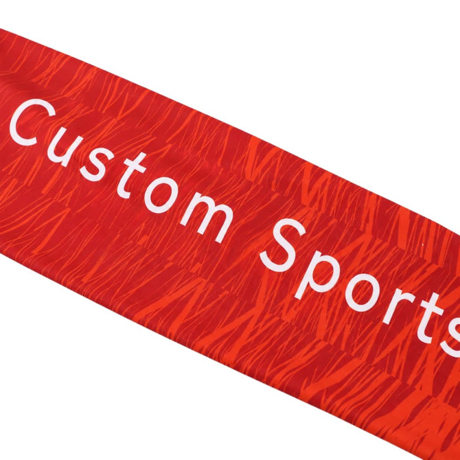 A red sports headband featuring a wavy pattern and prominent text. It has a logo or branding displayed on it.