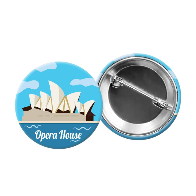 A round button badge featuring a blue design with the Sydney Opera House illustration and a metal pin back.