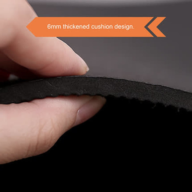 A hand holding the edge of a black yoga mat, highlighting its 6mm thick cushion design.