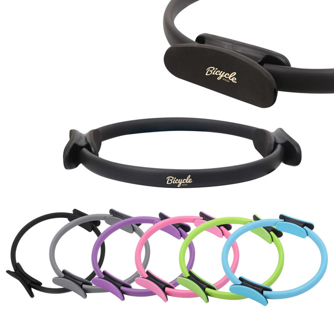 A Pilates circle in various colours including black, grey, pink, purple, and green, featuring a logo.