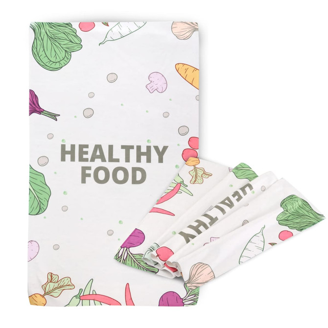 A tea towel featuring a colourful design of vegetables on a white background, with a logo included.