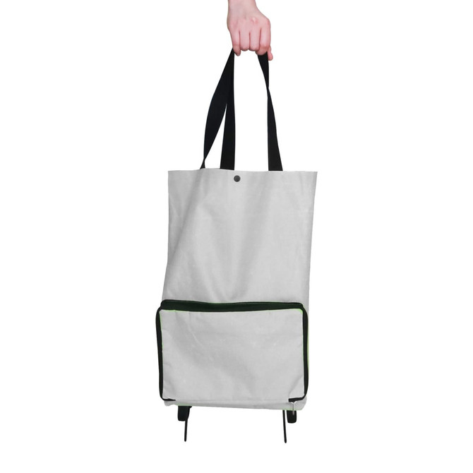 A grey collapsible shopping trolley bag with a green zippered pocket, held by a hand with black straps.