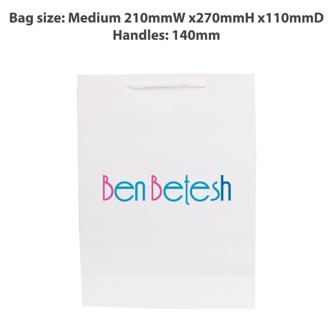 A white medium vertical paper bag with a fabric flat handle, featuring a logo on the front.