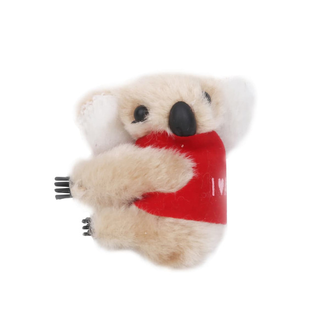 A plush toy koala with beige fur and a red shirt, featuring small black limbs and ears, holding onto a surface.